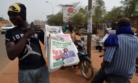 A street vendor sells newspapers in Ouagadougou on 3 December
