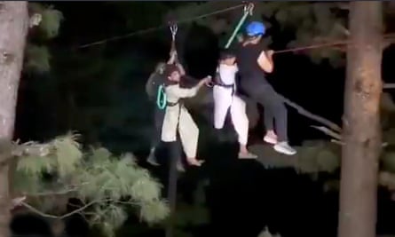 People being rescued via zip wire 