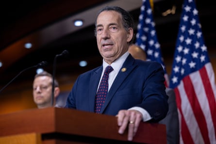 a man in a suit speaks into a microphone