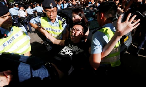 Pro-democracy activist Avery Ng is detained by Hong Kong police as he takes part in a protest demanding the release of Chinese Nobel rights activist Liu Xiaobo.