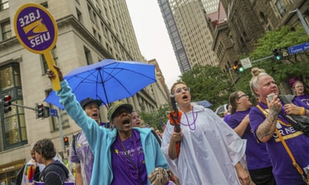 SEIU members Yvette Steele, holding sign at left, Mariko Marshman, center, and Shellie Lawrence, right, shout their support for unions during a Labor Day parade in downtown Pittsburgh, on 5 September.