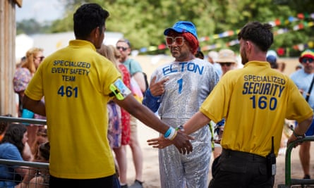 Rich Pelley dressed as Elton John with security guards