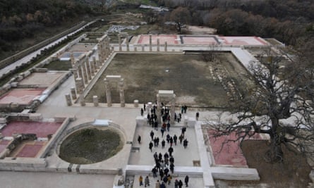 An aerial image of the Aigai palace, with dozens of people around the entrace.