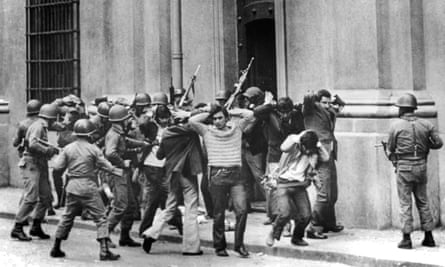 Aides of President Salvador Allende are hurried away from the La Moneda presidential palace, during the coup d’etat in Santiago, on 11 September 1973, led by Gen Augusto Pinochet.