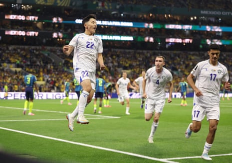 Abbosbek Fayzullaev jumps for joy after heading the Uzbekistan level