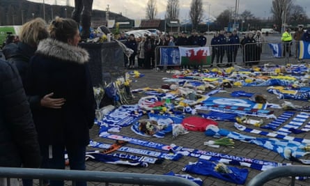 Emiliano Sala’s sister Romina Sala (second left) and her cousin Maria Sottini look at tributes to the footballer outside Cardiff City’s stadium