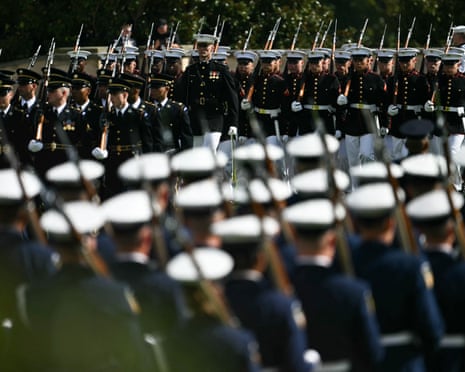 Military service members march in formation carrying rifles during a Pentagon POW/MIA ceremony