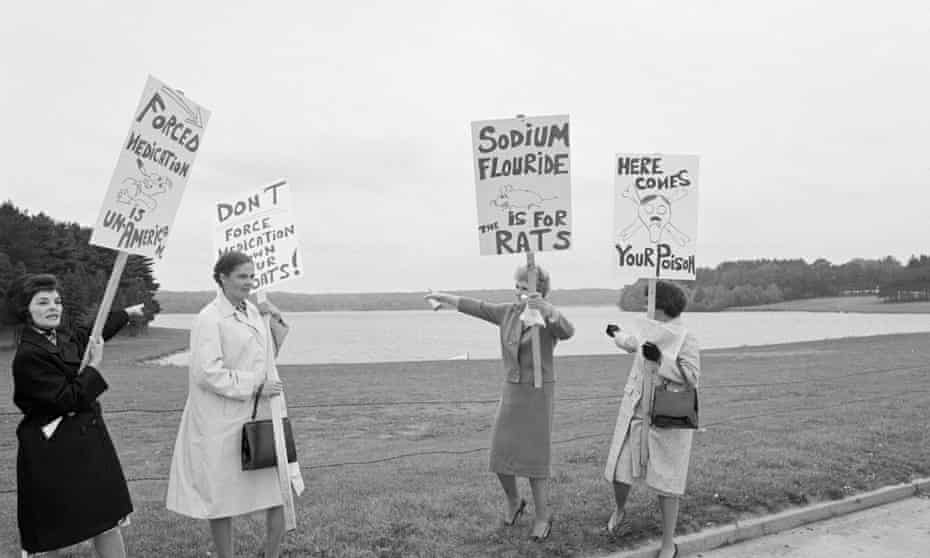 Picketers carrying signs protesting the fluoridation of New York City’s water supply in 1965 march in front of Kensico Reservoir.