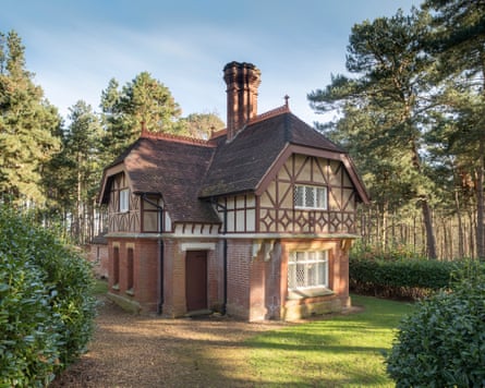 A Victorian gothic/half timbered cottage surrounded by trees.