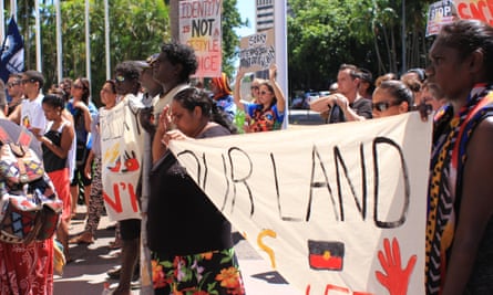 Protesters listen to Labor senator Nova Peris at the #sosblakaustralia rally outside parliament house in Darwin.