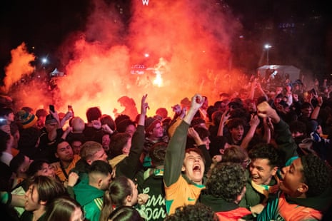 Flares are set off as fans celebrate a Socceroos goal at Tumbalong Park in Sydney.