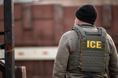 An Ice agent stands on a street