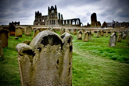 A gravestone in the foreground of Whitby Abbey.