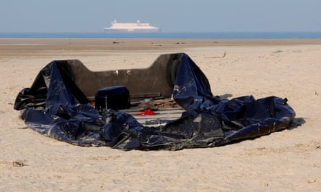 A damaged inflatable dinghy lies on the beach in Gravelines, near Calais, France, in December