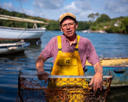 Jason Pascoe wearing a shirt, overalls and a cap