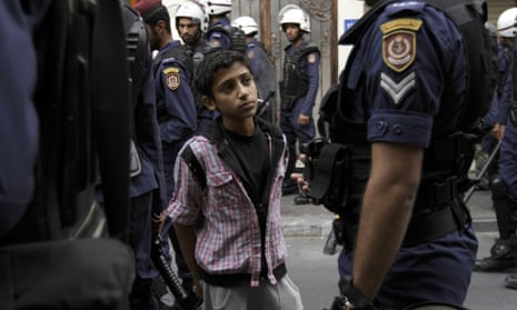 Bahraini police arrest a boy during anti-government protests in the capital of Manama in 2013.