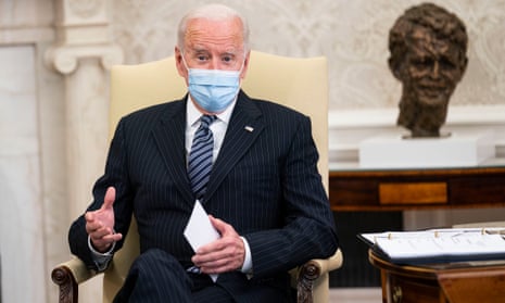President Joe Biden in the Oval Office, with mask on