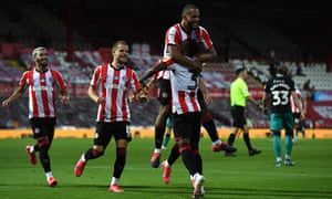Bryan Mbeumo celebrates scoring Brentford’s third goal with teammate Rico Henry.