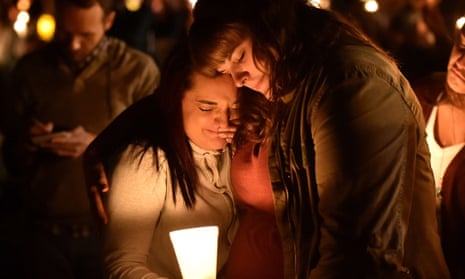 Mourners react during a vigil in Roseburg, Oregon on October 1, 2015, for ten people killed and seven others wounded in a shooting at a community college in the western US state of Oregon. 