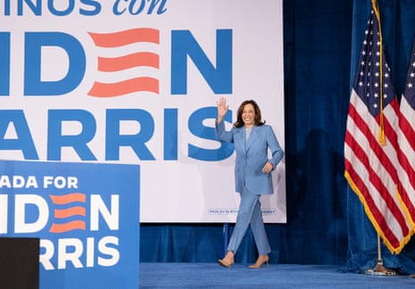 a woman waves as she walks on stage