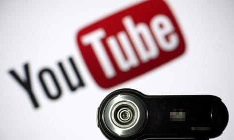 File photo of a webcam positioned in front of YouTube’s logo