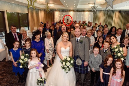 Large group photo of all the wedding guests behind the bride and groom