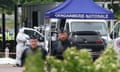 A forensic officer works as police officers patrol at the site of an attack in Incarville in the Eure region of northern France.