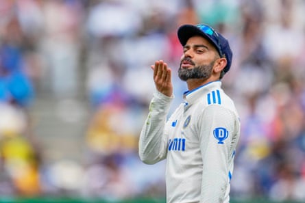 Virat Kohli gestures to a member of a crowd during play on the first day of the fourth Test between Australia and India at the MCG