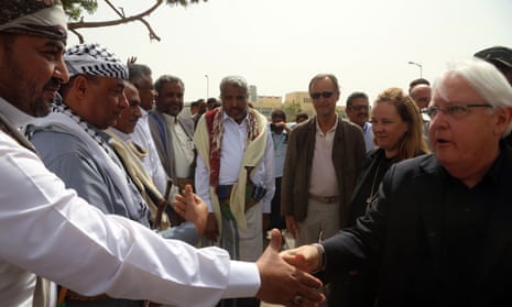 The UN special envoy for Yemen, Martin Griffiths, shakes hands with a Houthi-appointed local official in Hodeidah.