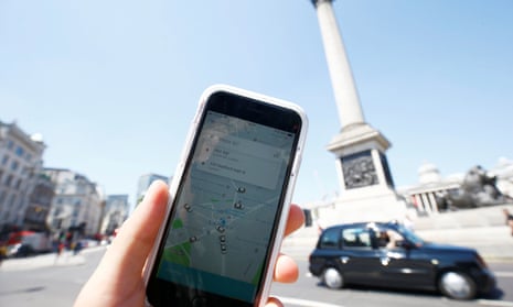 The Uber app and a black cab in London