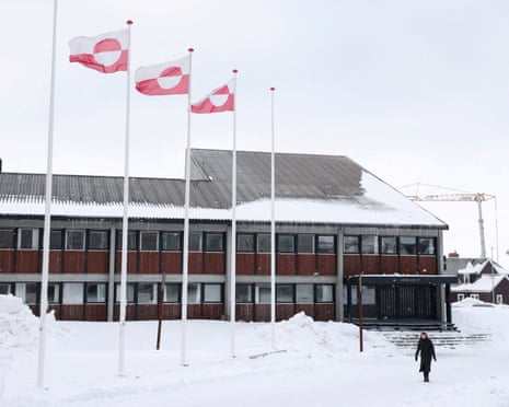 A woman walks past Greenland's parliament Inatsisartut in Nuuk, Greenland in March last year.