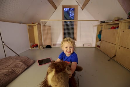 Three-year-old Tom in the roof space of the family’s tiny house.