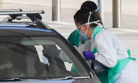 Medical staff wear PPE as they test a NHS worker at a drive-through Covid-19 testing facility in Rochdale.