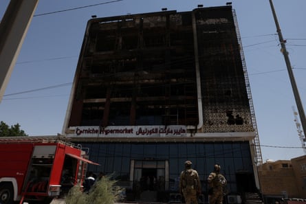 A fire truck stands next to the burned remains of a five-storey shopping centre in Kut, Iraq, on Thursday.