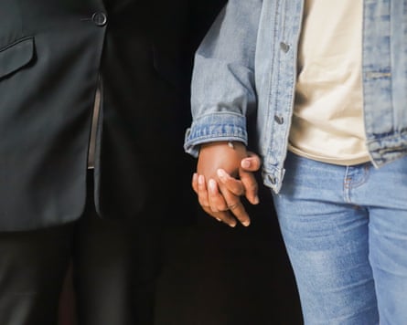 Closeup of the couple holding hands