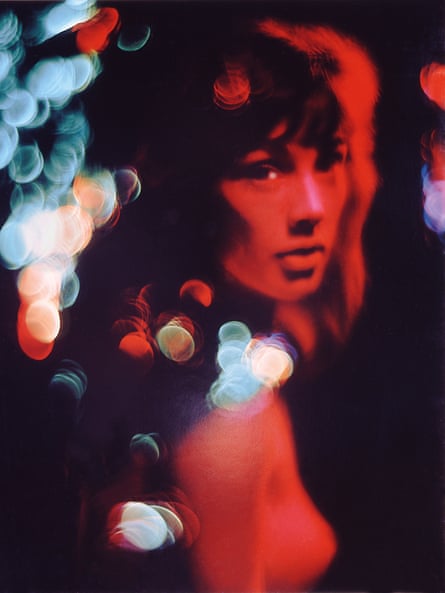 A woman looks at the camera in a red toned photograph called Cornelia, 1961.