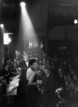 American jazz singer Billie Holiday in the spotlight during a performance