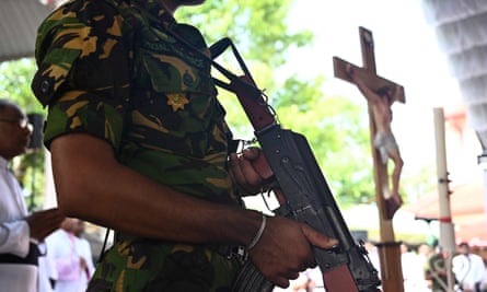 A soldier stands guard during a funeral service at St Sebastian’s church in Negombo
