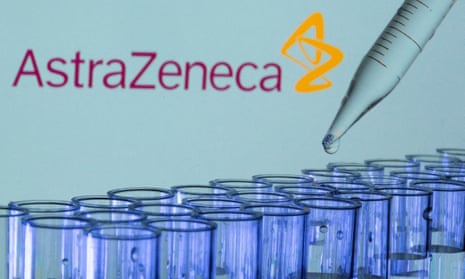 Test tubes are seen in front of a displayed AstraZeneca logo.