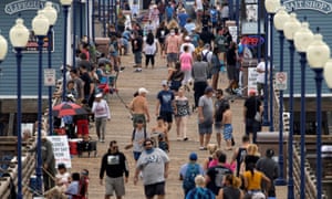 Few people wear masks or keep their distance as they walk on the Oceanside, California, last week.