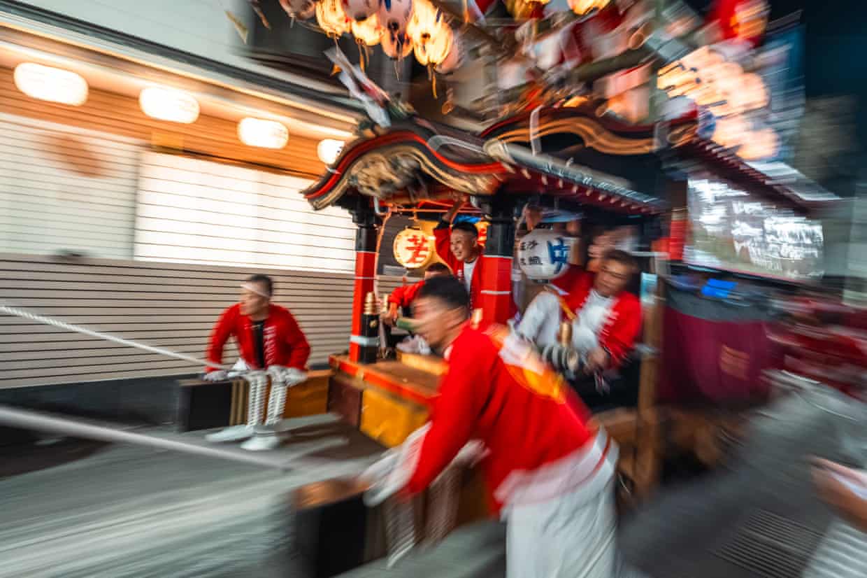 Young men pushing and pulling a decorative festival float in Anan, Tokushima.