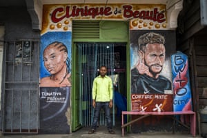 Palou, 27, poses in front of his hairdressing salon in Goma, Democratic Republic of Congo