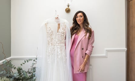 Nicola Clifford poses with her wedding gown at her residence in East London