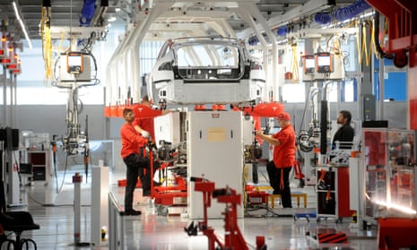 Tesla workers examine a Model S at the company’s factory in Fremont, California. 