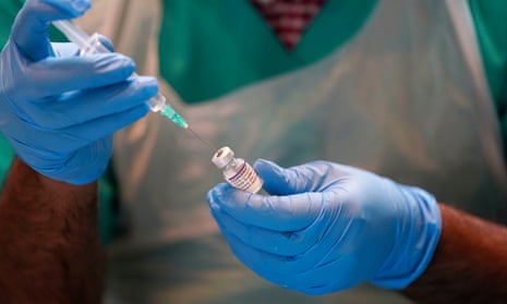 A pharmacist prepares a vaccine at a clinic in Oxford.