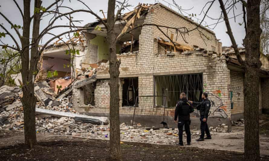 Officers inspect a nursery hit by a rocket in Kramatorsk. The attack had been intended for the local security services HQ