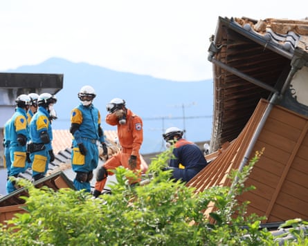 Rescue operations continue at a collapsed house in Yatsushiro City.