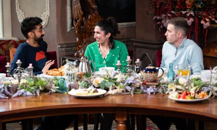 Three people sat around a breakfast table