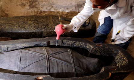 An archaeologist works on another sarcophagus discovered inside the tomb.
