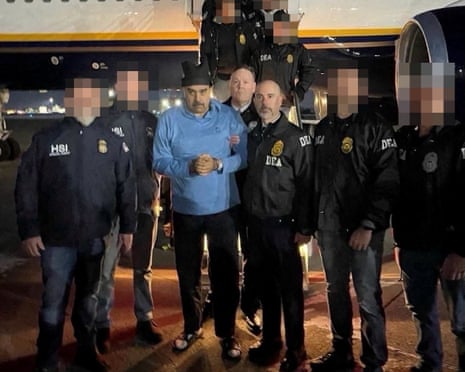 Venezuelan leader Nicolás Maduro poses next to US US drug enforcement officers as he is led in custody from a US federal airplane in Newburgh, New York, on Saturday.